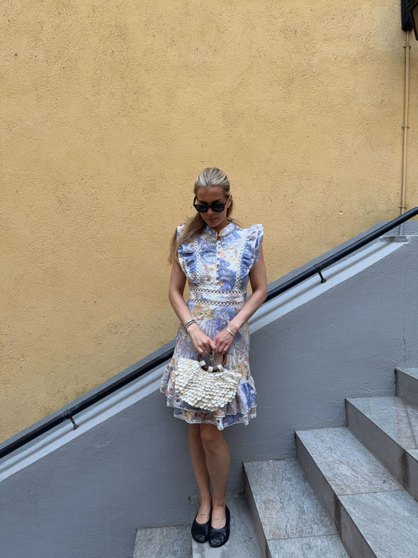 Blue floral broderie anglaise mini dress with ruffled cap sleeves and scalloped hem