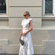 White broderie anglaise maxi dress with ruffled cap sleeves and tiered scalloped hem