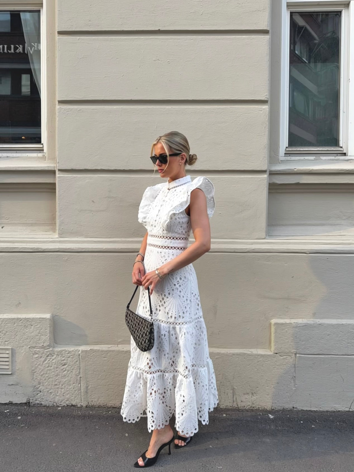White broderie anglaise maxi dress with ruffled cap sleeves and tiered scalloped hem