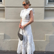 White broderie anglaise maxi dress with ruffled cap sleeves and tiered scalloped hem