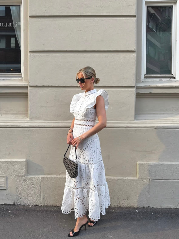 White broderie anglaise maxi dress with ruffled cap sleeves and tiered scalloped hem