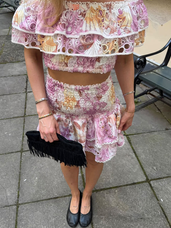 Pink floral broderie anglaise off-shoulder top with layered ruffles and smocked bodice