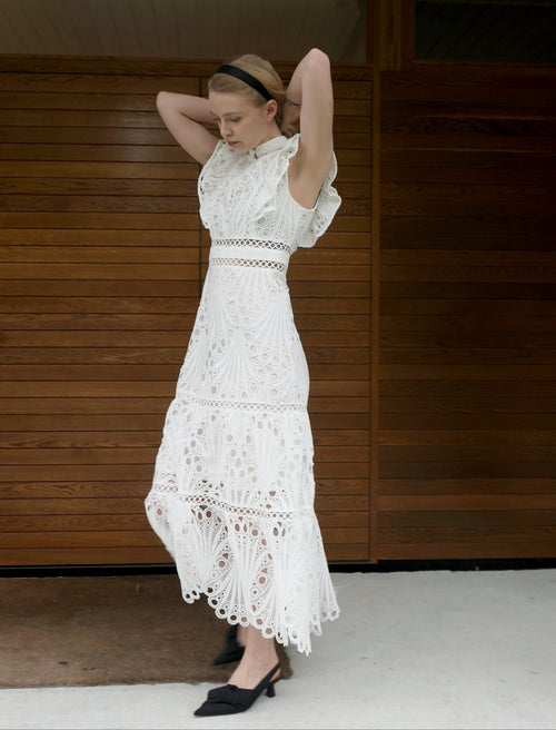 White broderie anglaise maxi dress with ruffled cap sleeves and tiered scalloped hem