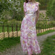 Pink floral broderie anglaise maxi dress with ruffled cap sleeves and tiered scalloped hem