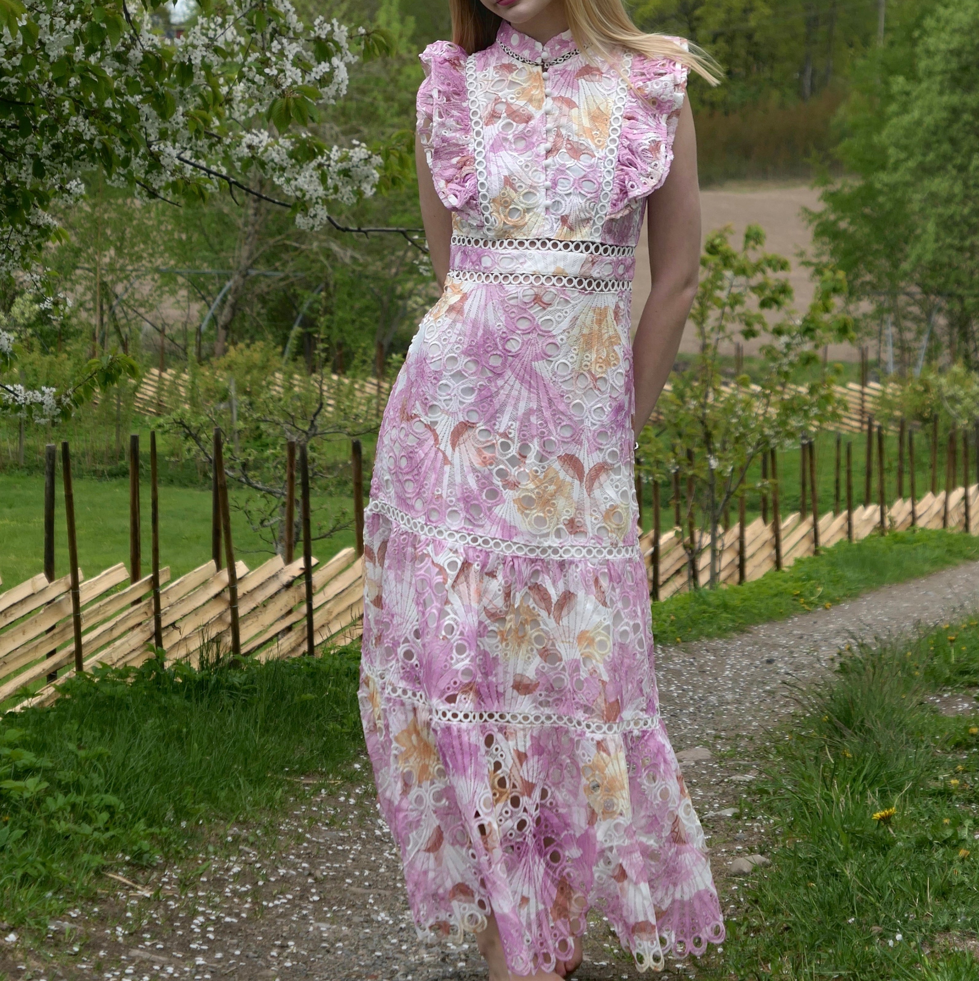 Pink floral broderie anglaise maxi dress with ruffled cap sleeves and tiered scalloped hem