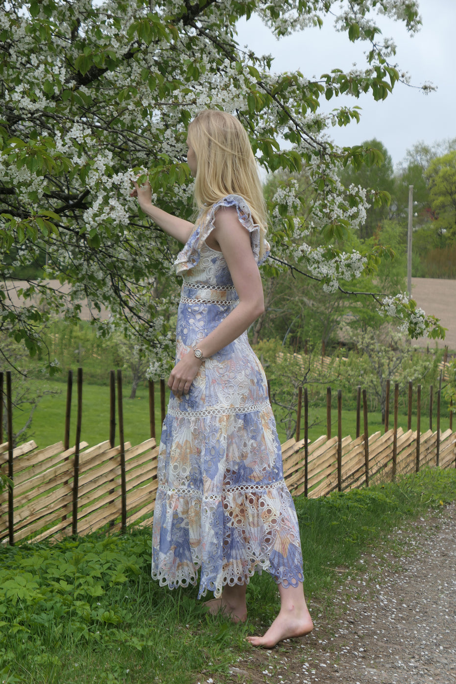 Blue floral broderie anglaise maxi dress with ruffled cap sleeves and tiered scalloped hem