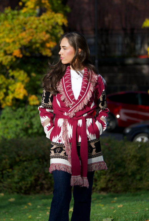 Burgundy merino wool wrap cardigan with bold Nordic knit pattern and fringed shawl collar