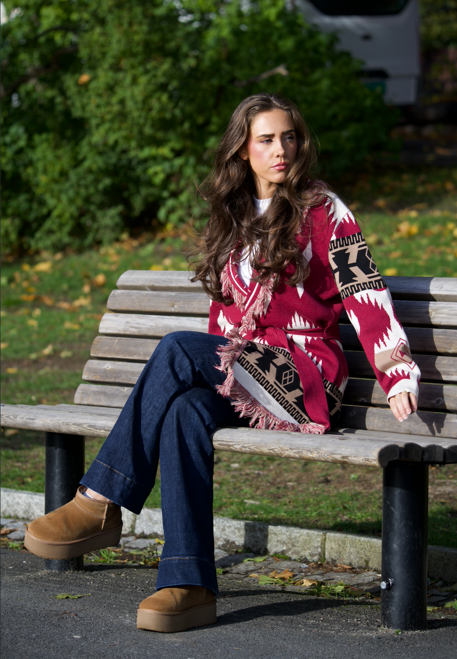Burgundy merino wool wrap cardigan with bold Nordic knit pattern and fringed shawl collar