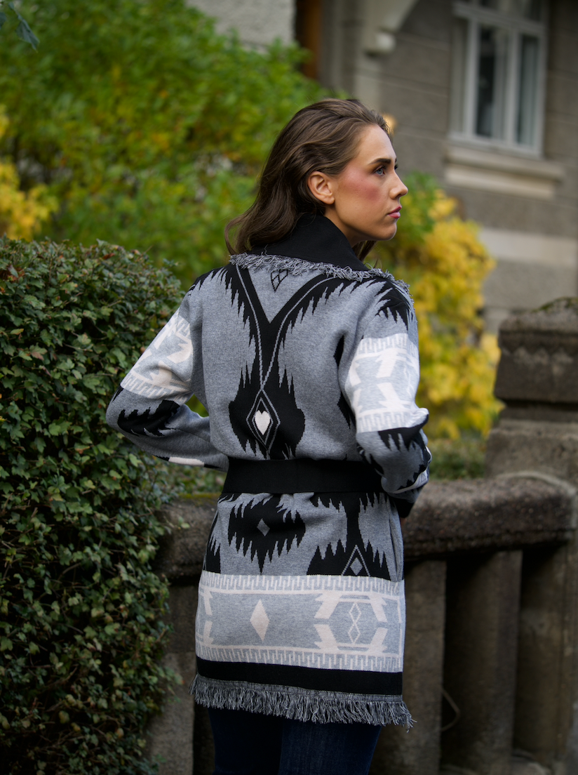 Grey merino wool wrap cardigan with bold Nordic knit pattern and fringed shawl collar
