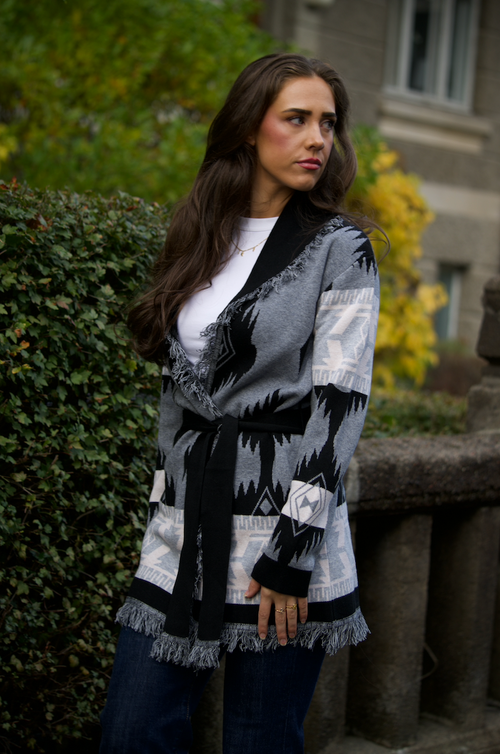 Grey merino wool wrap cardigan with bold Nordic knit pattern and fringed shawl collar