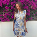 Blue floral broderie anglaise mini dress with ruffled cap sleeves and scalloped hem