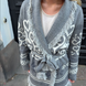 Grey merino wool wrap cardigan with Selbu rose motif and fringed shawl collar